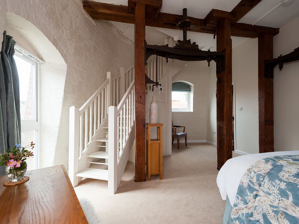 Bedroom with stairs to top floor.